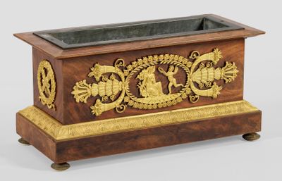 a wooden planter with a gold decoration on it