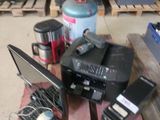 a pile of electronics on a pallet in a garage