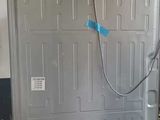 an image of a refrigerator in a garage with a door open