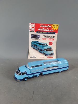 a toy bus that is sitting next to a magazine