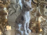 a dog figurine sitting on top of a silver tray