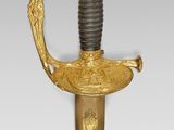 an old sword with a gold and black handle on a white background