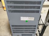 a close up of a metal cart with a green button on it