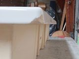 a white bath tub sitting in a room next to a wall