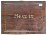 an old wooden box with the word boston written on it