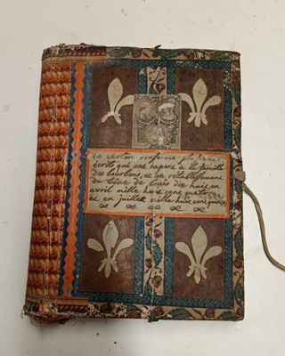 an old book sitting on top of a white table covered in writing