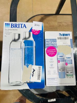 a bottle of water sitting on top of a table next to a package of toothpaste