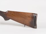 a close up of a rifle on a white surface with a white background