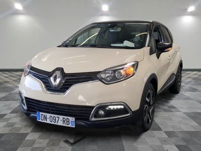 the front of a white car is parked on a checkered floor