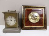 two clocks sitting next to each other on a table