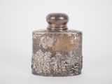 an image of a silver glass jar with a lid on a white surface