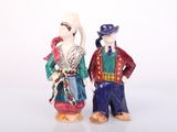 two figurines of a man and a woman standing next to each other