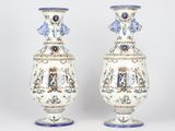pair of vases with blue and white designs on them sitting on a table