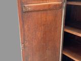an old wooden cabinet with shelves and shelves in it