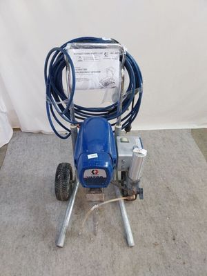 a picture of a blue airless paint sprayer with a hose attached to it