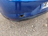 a blue car that has a hole in the front of it