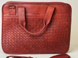an image of a red leather bag with a strap