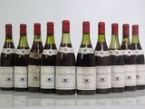 six bottles of wine are lined up in a row on a table