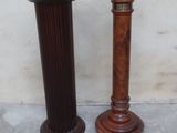 two tall wooden candlesticks sitting next to each other