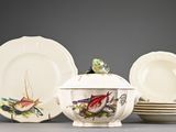 a group of plates and a bowl with a bird on it