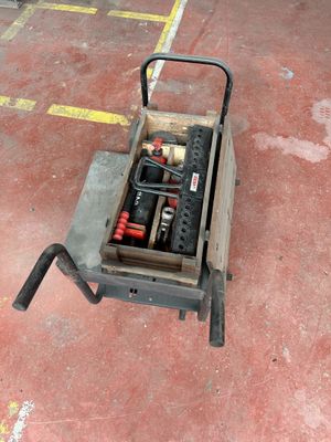 a small cart with tools in it on the floor