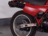 a red motorcycle that is parked in a garage