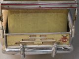 a small yellow and red stove sitting on a table