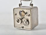 a small silver radio sitting on top of a white table