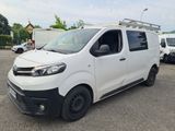 the white van is parked in a parking lot with other vehicles