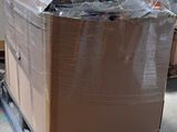 a large box sitting on a pallet in the middle of a room