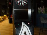 a game machine that has a dart in the middle of it