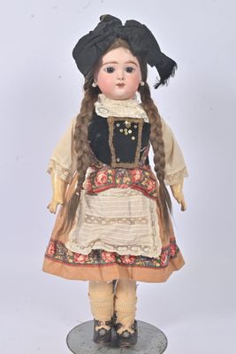 a doll that is wearing a dress and a hat