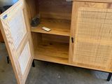 a wooden cabinet with a door open on the floor