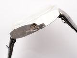 an image of a close up of a watch on a white surface