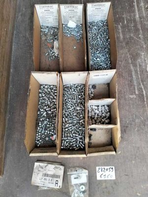 several boxes of screws and nuts are sitting on the floor