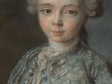 portrait of a young boy in a blue jacket and hat