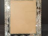 an image of a silver picture frame on a black surface