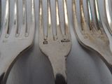 a lot of forks that are sitting on a table