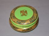 a green and gold box with a picture of a bird on it
