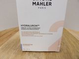 a box on a table that has a bottle of hydrating cream on it