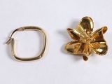 two pieces of gold colored metal with a flower on top of them