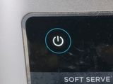 a close up of a button on the side of a machine
