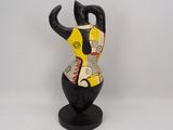 ceramic figurine of a woman in a yellow and black dress