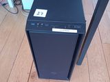 a small black computer on the floor next to a table