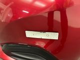 a close up of a red motorcycle with a number plate on it