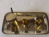 a silver tray with a toothbrush and a tooth brush in it
