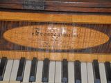 a close up of a piano that has a sign on it