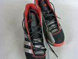 a pair of black and red shoes on a white surface