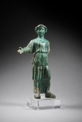 an image of a statue of a woman in a green dress