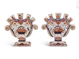 pair of antique vases with floral designs on them on a white background